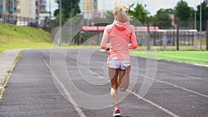 Athletic fit Caucasian woman warming up for jog