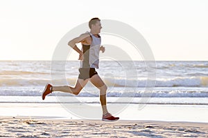 Athletic fit and strong runner man training on Summer sunset beach in sea shore running and fitness workout in sport and healthy l