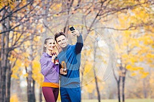 Athletic fitness couple taking selfie with their phone