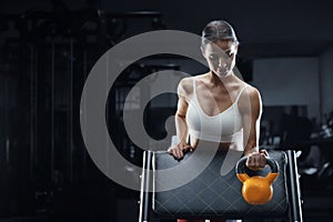 Athletic fitness woman with kettlebell