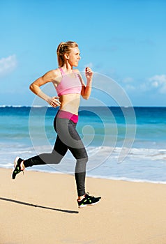 Athletic Fitness Woman Running on the Beach