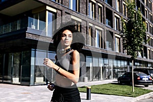 An athletic girl is jogging on the city street