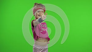 Athletic girl in pink sportswear is waving her hand doing hello gesture isolated over chroma key