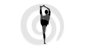 Athletic girl standing in yoga asana utthita hasta Padangustasana, extended hand to big toe yoga pose stretched hand