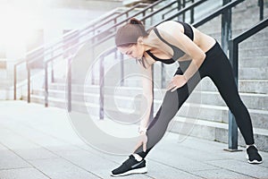 Athletic girl stretching before training