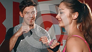 Athletic girl working with the trainer individually. Young brunette boxing with a trainer. Man and woman doing cardio