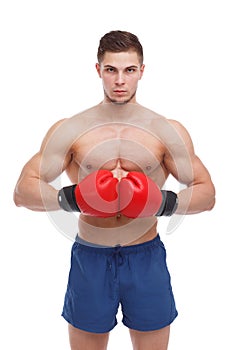 Athletic guy boxer with a bare torso and boxing gloves is connected by a brush at the abdominal level.