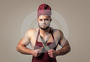 athletic guy with strong muscles in chef apron cooking food, butchery