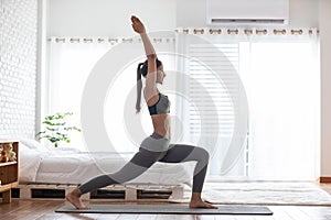 Athletic Healthy Asian indian woman in sportswear workout excercise at home in bedroom,Young woman with slim body cardio aerobic photo