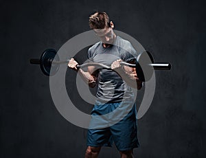 Athletic male biceps barbell workout.