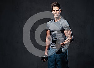 Athletic male biceps dumbbell workout.