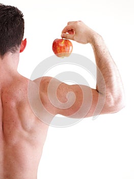 Athletic male body builder holding red apple