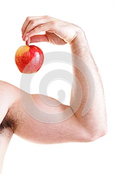 Athletic male body builder holding red apple