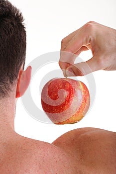 Athletic male body builder holding red apple