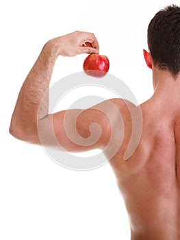 Athletic male body builder holding red apple