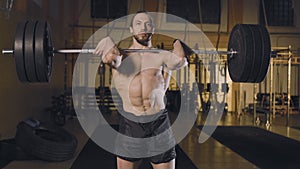 Athletic man doing barbell snatch