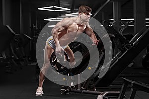 Athletic man doing bent over row muscles