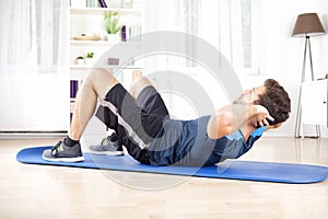 Athletic Man Doing Curl Ups Exercise at Home