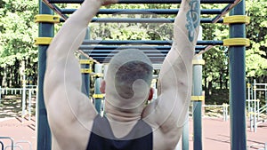 Athletic man doing exercise outdoor. Workout. Street training and physical activity
