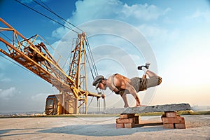 Athletic man doing exercise push ups on hands.