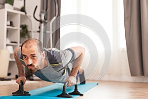 Athletic man doing push-up workout on yoga mat