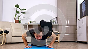 Athletic man doing push ups at home