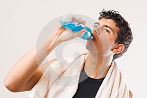 Athletic man drinking energy drink