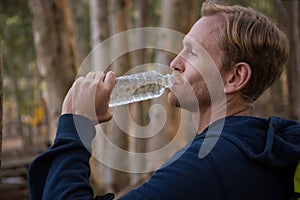 Athletic man drinking water from a bottle