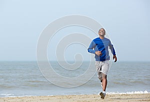 Athletic man enjoying a jog at the beach