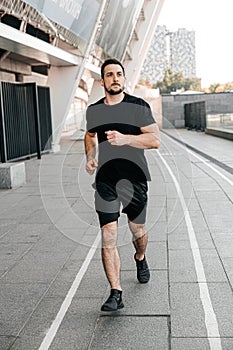 Athletic man jogging in the city. Healthy lifestyle. Man running. Urban city lifestyle. Active living. Outdoor fitness