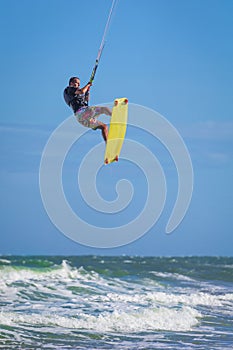 Athletic man jump on kite surf board sea waves