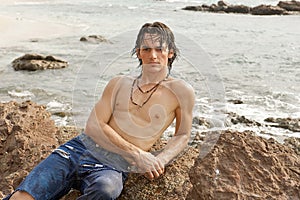 Athletic man laying on the beach in Costa Rica.