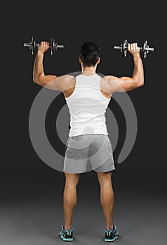 Athletic man lifting weights