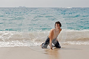 Athletic man playing on the beach in Costa Rica. photo