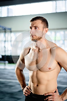 Athletic man posing hardcore in the gym
