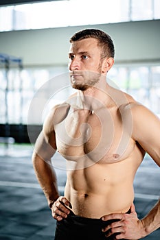 Athletic man posing hardcore in the gym