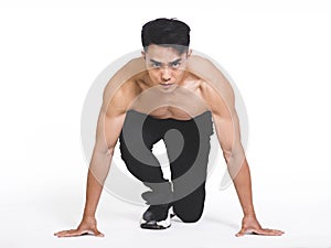 Athletic man ready for start running, isolated over  white background