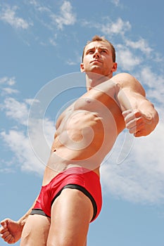 athletic man in red briefs