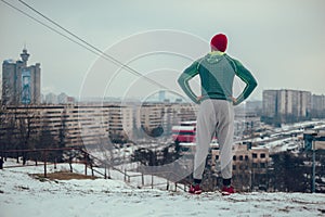 Athletic man resting while looking at the cityscape