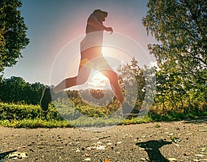 The Athletic man running on a forest trail. The man run