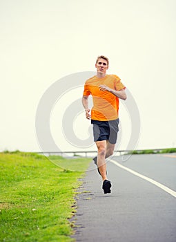 Athletic man running outside, training outdoors