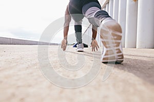 Athletic Man in Running Start Position and Looking Into the Distance at the Park