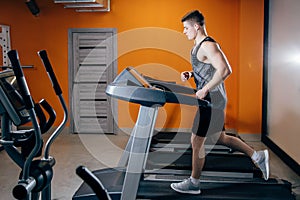 Athletic man running on the treadmill