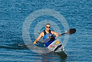 Athletic man in sea kayak