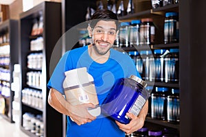 Athletic man seller demostration sport nutrition products in shop photo