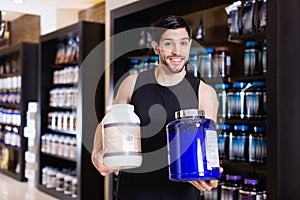 Athletic man seller demostration sport nutrition products in shop photo