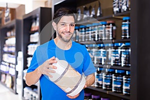 Athletic man seller demostration sport products photo