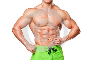 athletic man showing abdominal muscles without fat, isolated over white background. Muscular male fitness model abs
