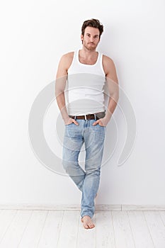 Athletic man standing at wall