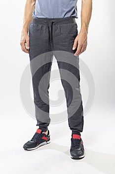 athletic man in sweatpants and sneakers on a white background
